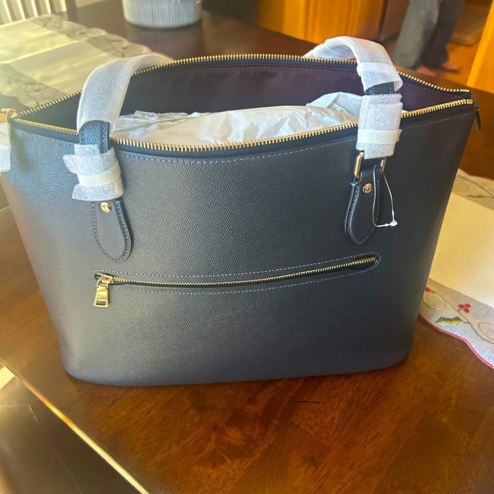 Black coach purse. Brand new. Still has wrapping on handles.